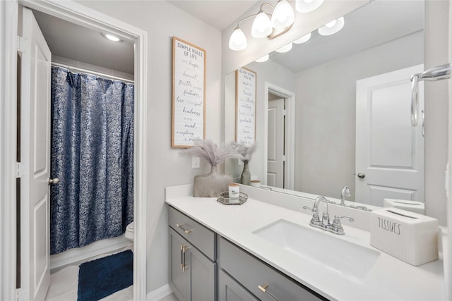 bathroom featuring vanity, toilet, and a shower with shower curtain