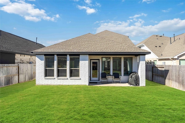 rear view of house featuring a yard and a patio