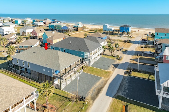 drone / aerial view with a beach view and a water view