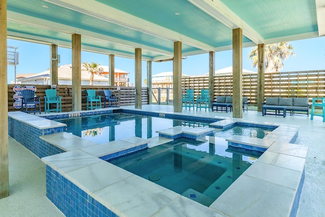 view of pool featuring an outdoor living space, an indoor in ground hot tub, and a patio area