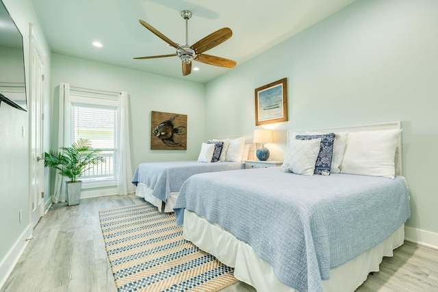 bedroom with light hardwood / wood-style flooring and ceiling fan