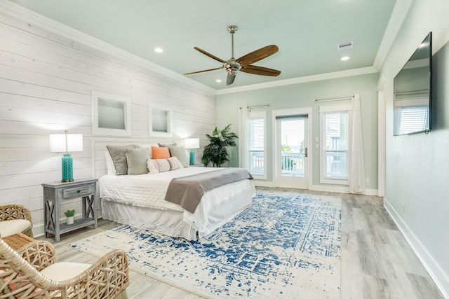 bedroom featuring crown molding, ceiling fan, access to exterior, wooden walls, and light wood-type flooring