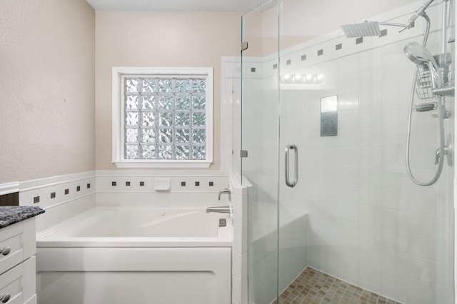 bathroom with vanity and separate shower and tub