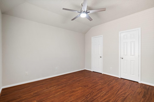 unfurnished bedroom with lofted ceiling, dark wood-type flooring, and ceiling fan