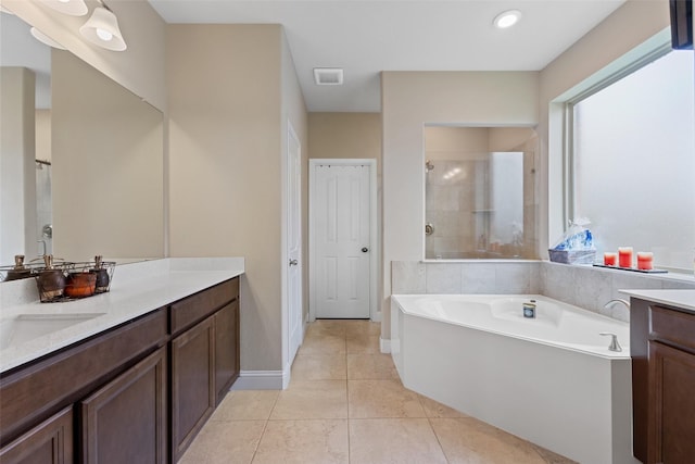 bathroom with vanity, shower with separate bathtub, and tile patterned floors