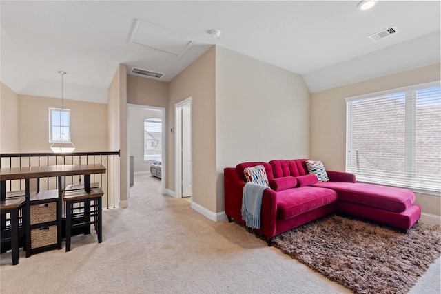 carpeted living room with vaulted ceiling