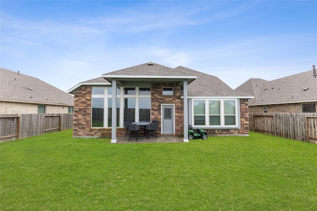 rear view of property with a patio area and a lawn