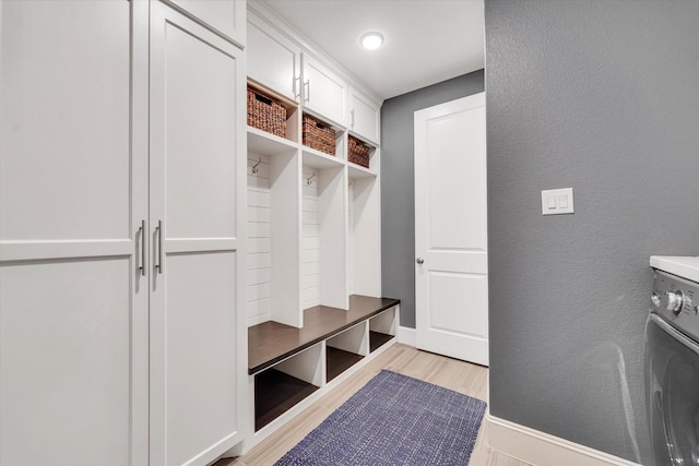 mudroom featuring washer / clothes dryer and light hardwood / wood-style flooring