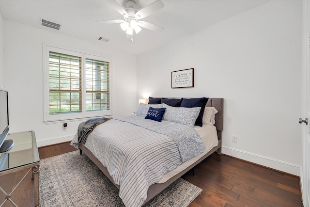 bedroom with dark hardwood / wood-style floors and ceiling fan