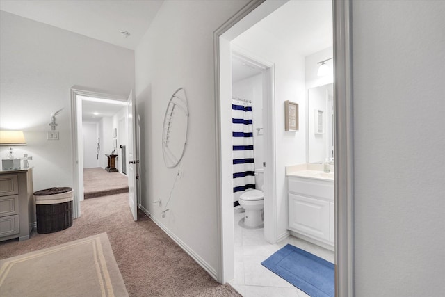 bathroom with vanity, curtained shower, and toilet