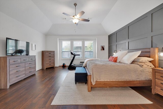 bedroom featuring dark hardwood / wood-style flooring, lofted ceiling, and ceiling fan