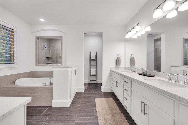 bathroom featuring vanity and plus walk in shower