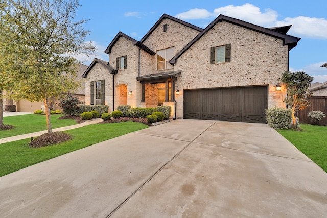 view of front of house with a garage and a front lawn