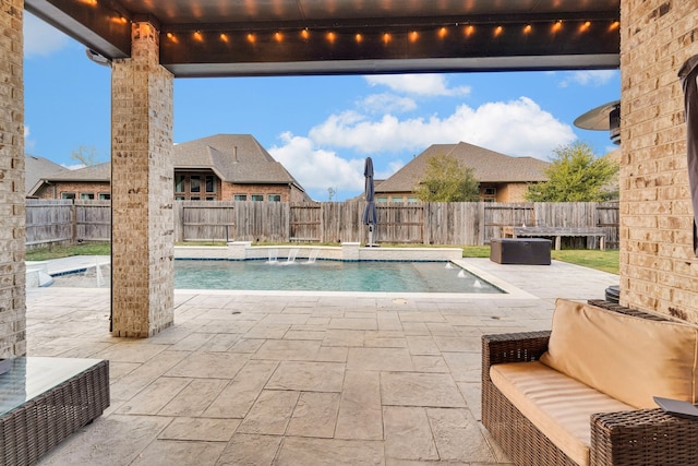 view of pool featuring pool water feature, an outdoor living space, and a patio