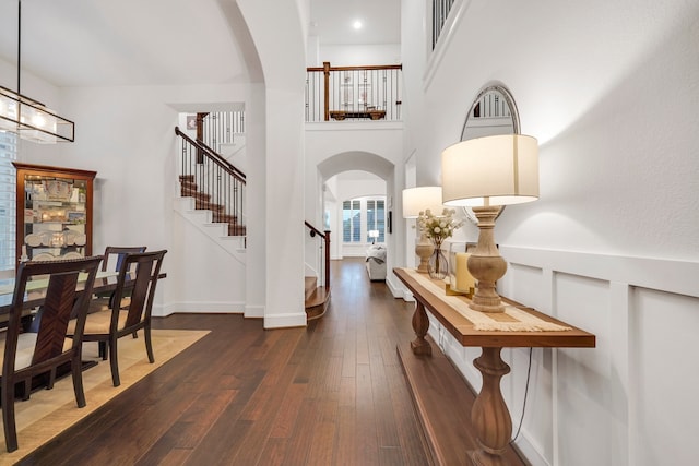 entrance foyer featuring dark wood-type flooring and a notable chandelier