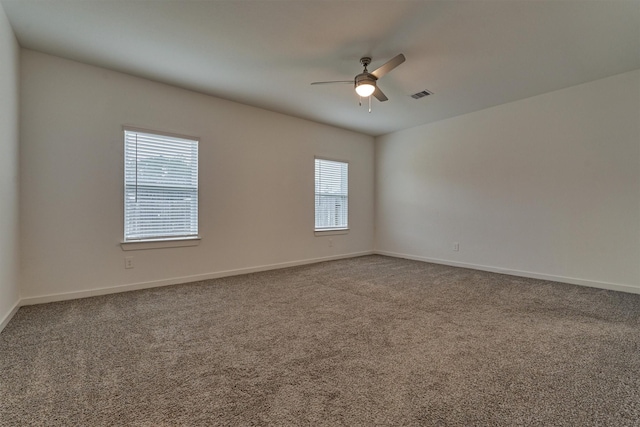 carpeted empty room featuring ceiling fan