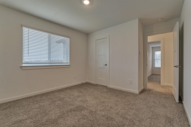 unfurnished bedroom featuring light carpet