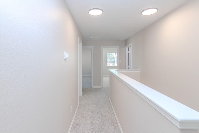 corridor with light colored carpet