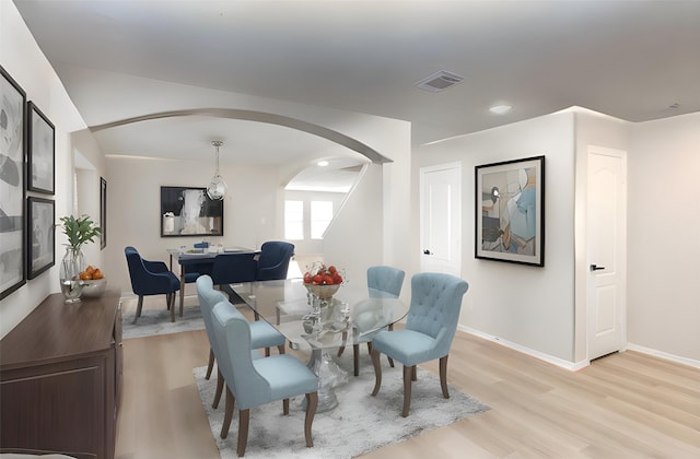 dining space with light hardwood / wood-style flooring