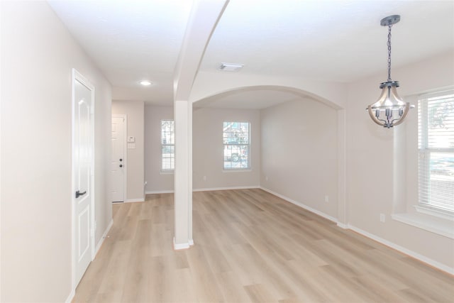 empty room with plenty of natural light and light wood-type flooring