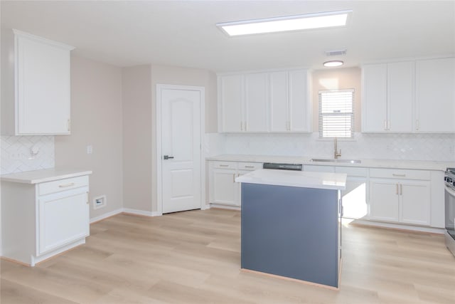 kitchen with a center island, sink, and white cabinets