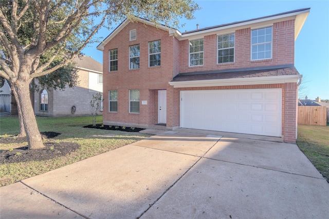 view of front of property with a garage and a front yard