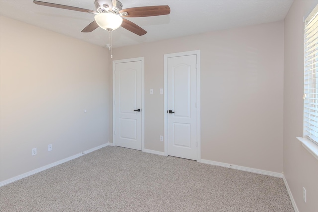 unfurnished bedroom with ceiling fan and light carpet