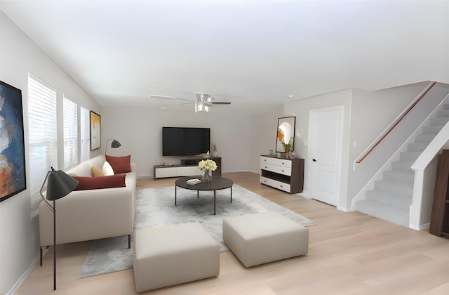 living room featuring light hardwood / wood-style flooring and ceiling fan