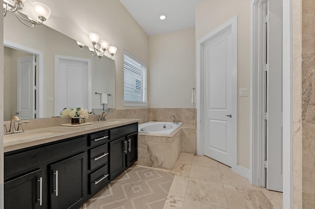 bathroom featuring vanity, tile patterned floors, tiled bath, and a chandelier