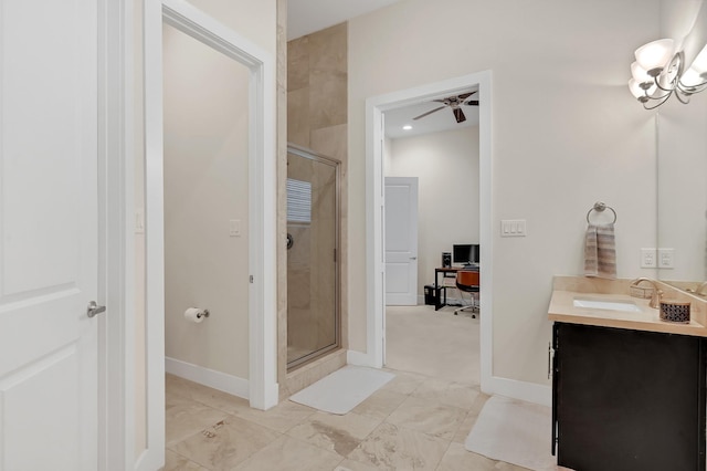 bathroom featuring an enclosed shower, vanity, and ceiling fan with notable chandelier