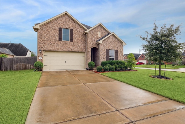 view of property featuring a garage and a front yard