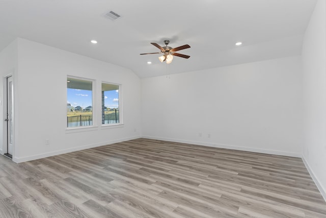 unfurnished room featuring lofted ceiling, ceiling fan, and light hardwood / wood-style flooring