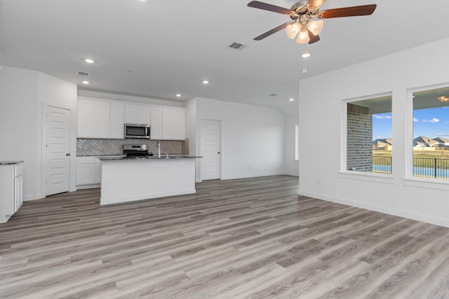 interior space with ceiling fan and light hardwood / wood-style flooring