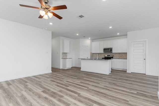 unfurnished living room with ceiling fan, sink, and light hardwood / wood-style flooring