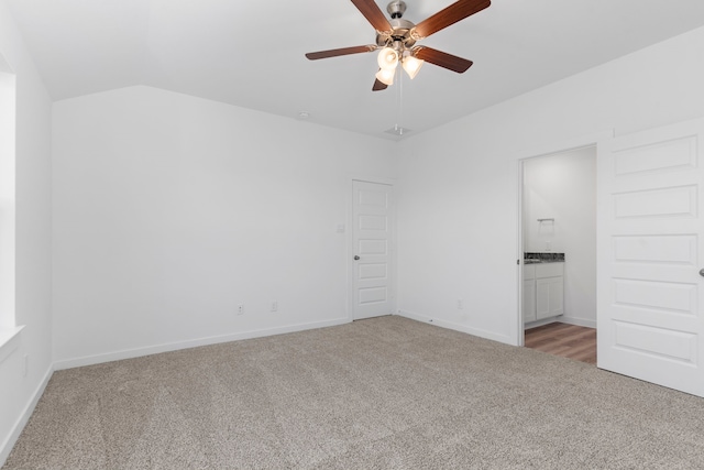 empty room featuring ceiling fan, light colored carpet, and lofted ceiling