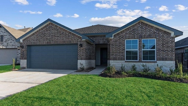 view of front of house featuring a garage and a front lawn