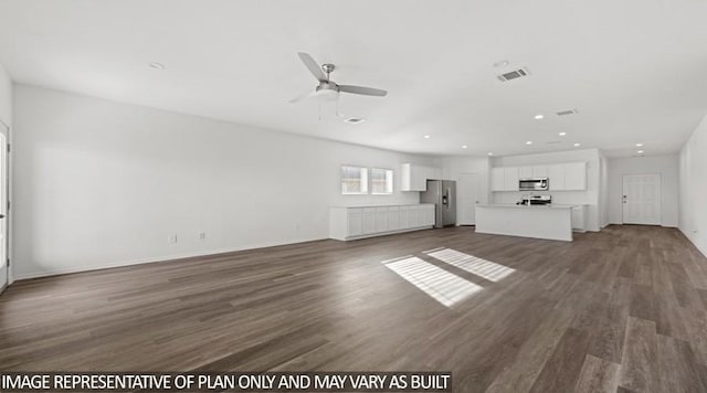 unfurnished living room featuring ceiling fan and dark hardwood / wood-style flooring