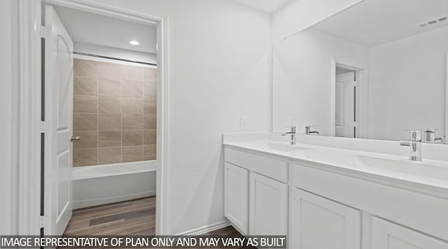 bathroom featuring tiled shower / bath combo, vanity, and hardwood / wood-style floors