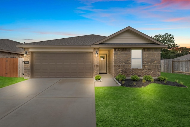 ranch-style house with a garage and a yard