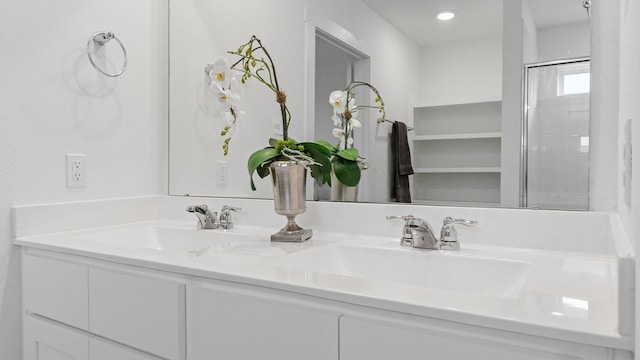 bathroom with vanity and a shower with shower door