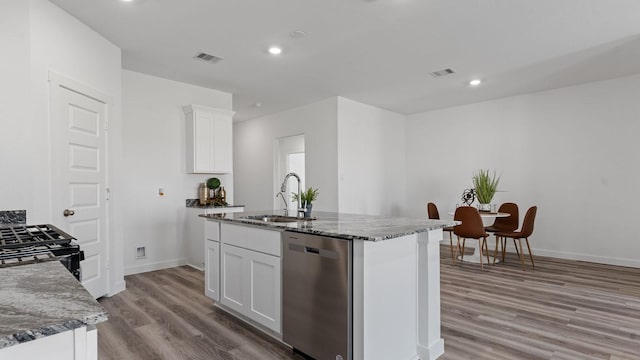 kitchen with a center island with sink, white cabinetry, sink, and stainless steel dishwasher