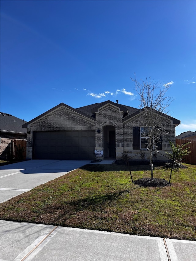 view of front of property with a garage and a front yard