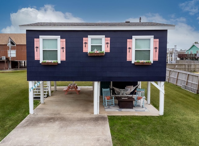 back of house with a lawn