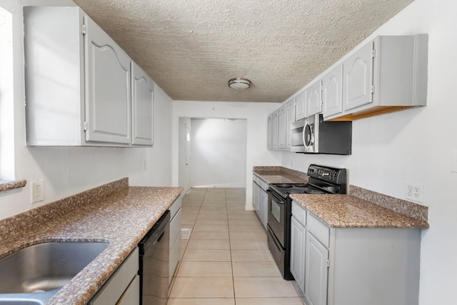 kitchen featuring light tile patterned floors and black appliances