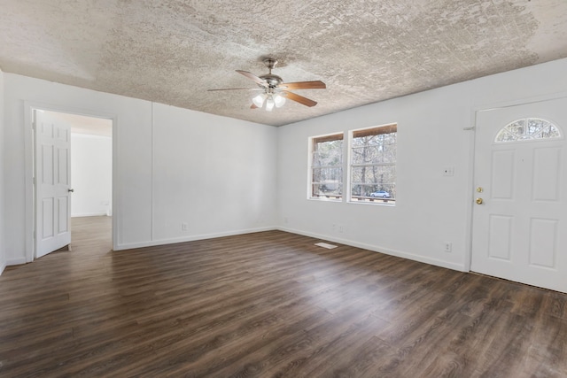 foyer with ceiling fan, dark hardwood / wood-style floors, and a textured ceiling