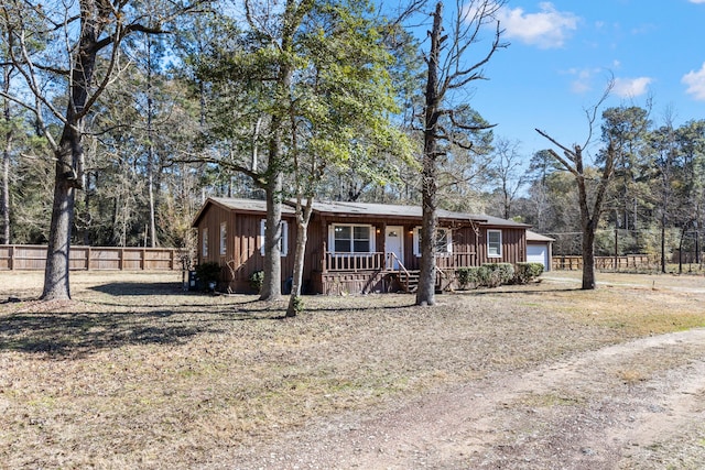 ranch-style house featuring a porch and a garage