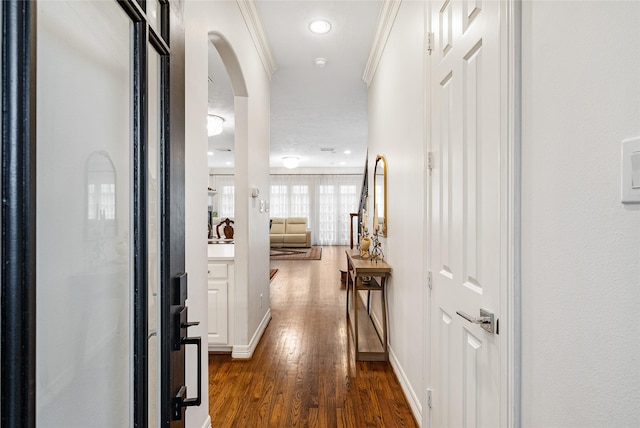 corridor with dark hardwood / wood-style flooring and crown molding