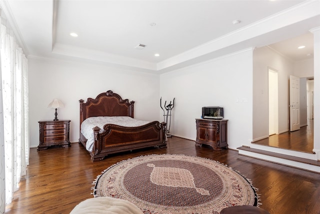 bedroom featuring a tray ceiling and dark hardwood / wood-style flooring