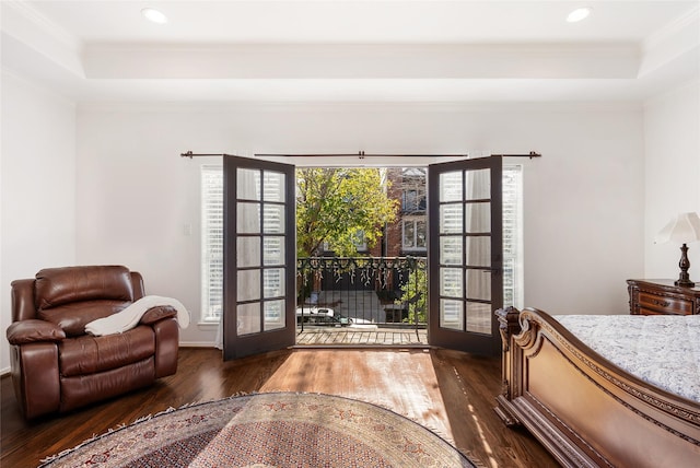 bedroom featuring a tray ceiling, dark hardwood / wood-style flooring, and french doors