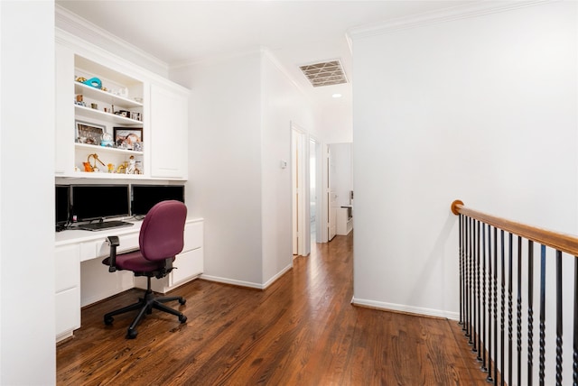 office featuring dark hardwood / wood-style flooring, built in shelves, built in desk, and crown molding